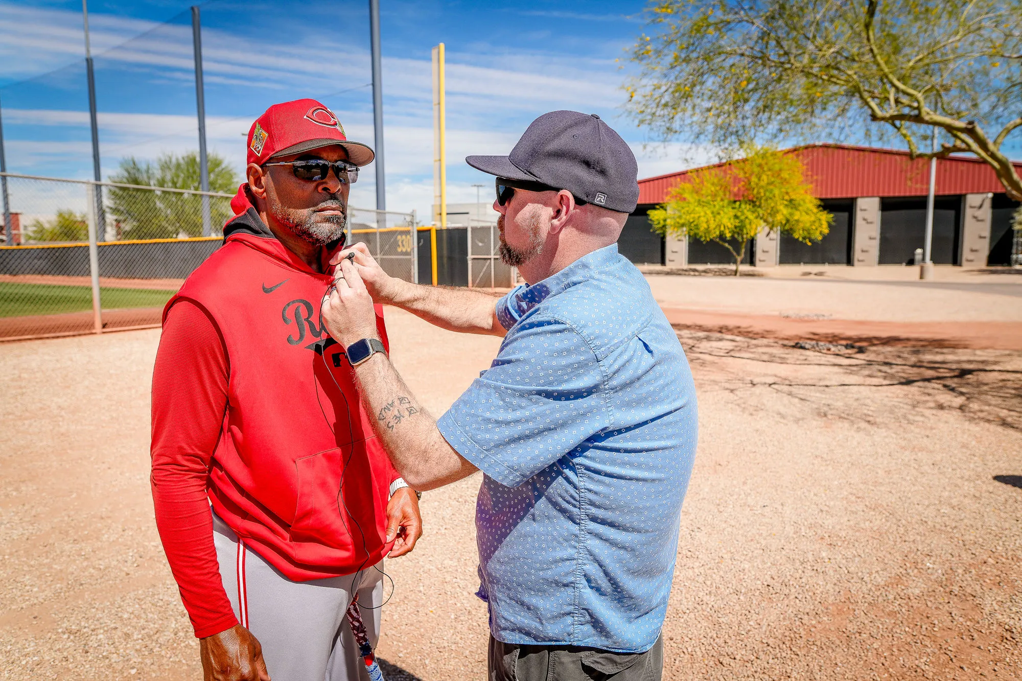 Isaac Stambaugh setting up a mic on a Cincinnati Reds production at spring training